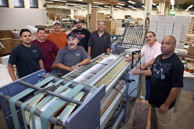 Albert Hererra and David Garcia bring quality binding to Printing Services products with the Heidelberg Saddle Stitcher